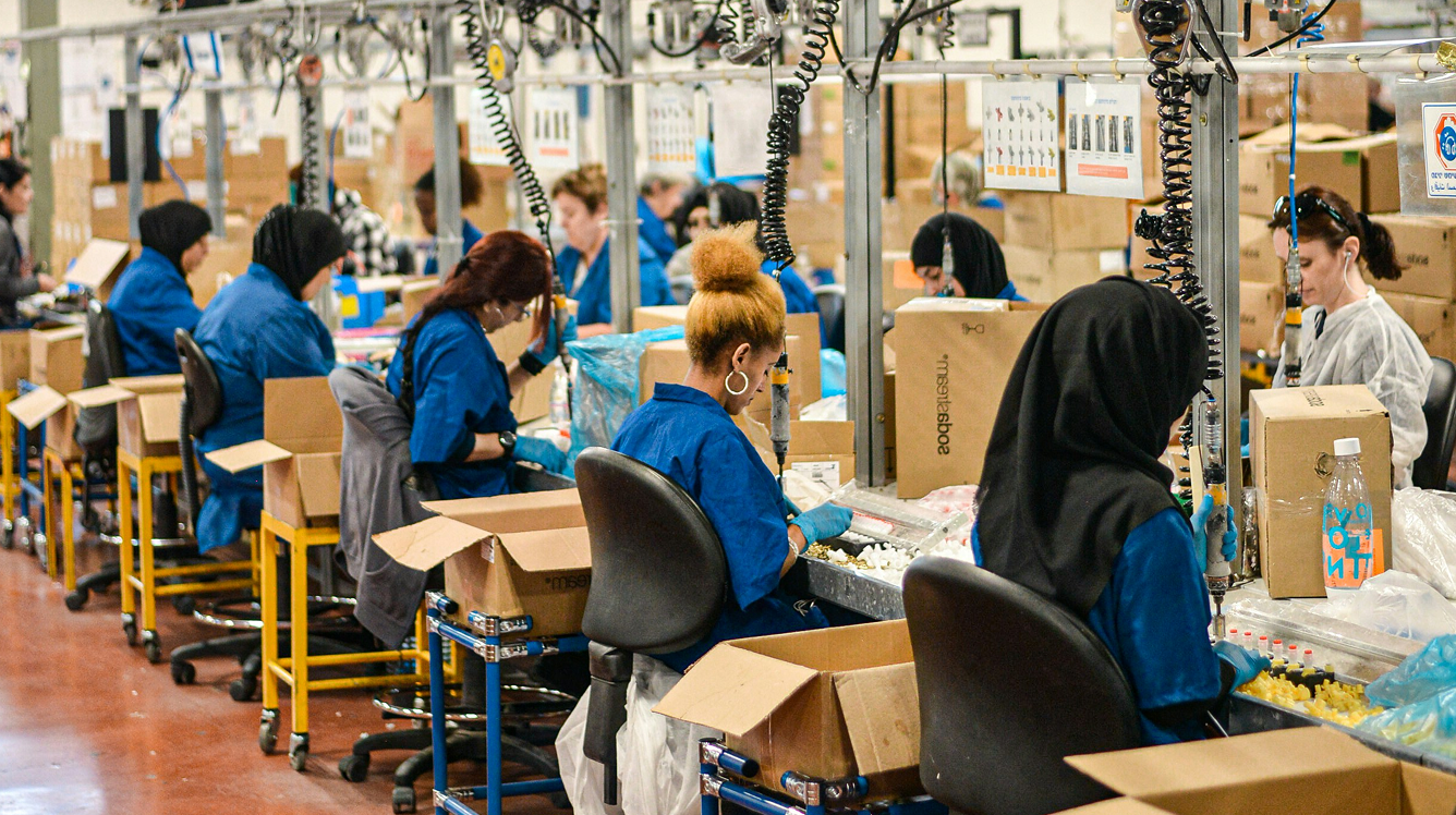 People working on an industrial production line