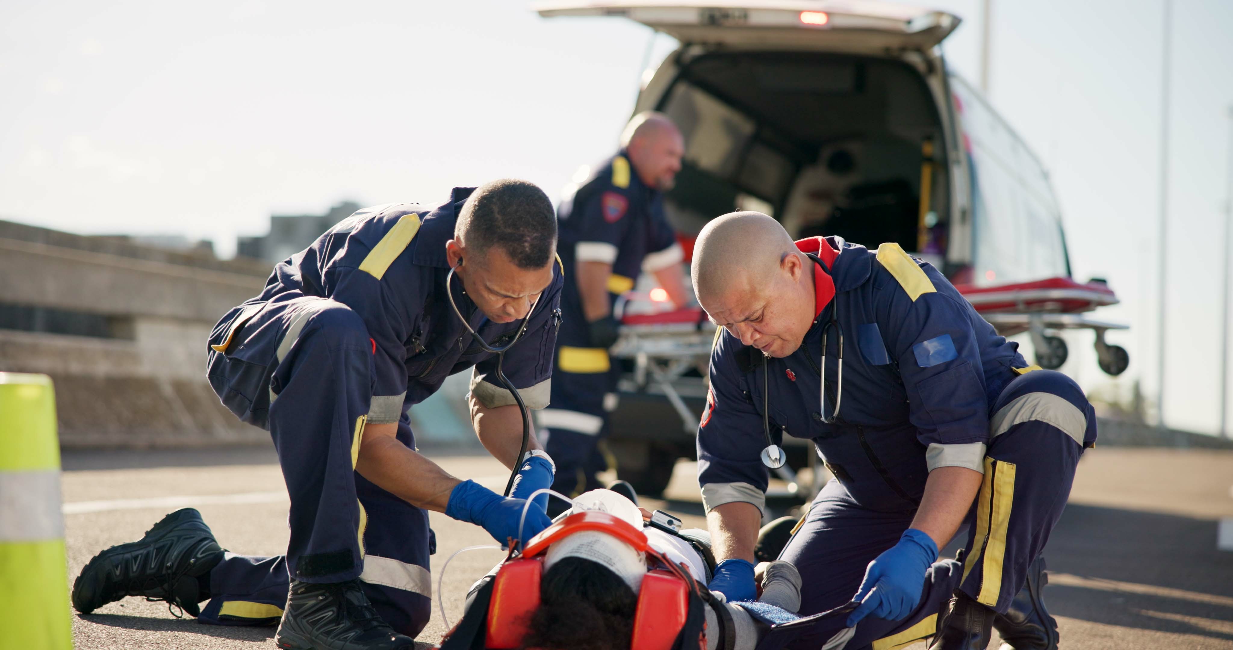 Paramedic crew lifting a patient stretcher