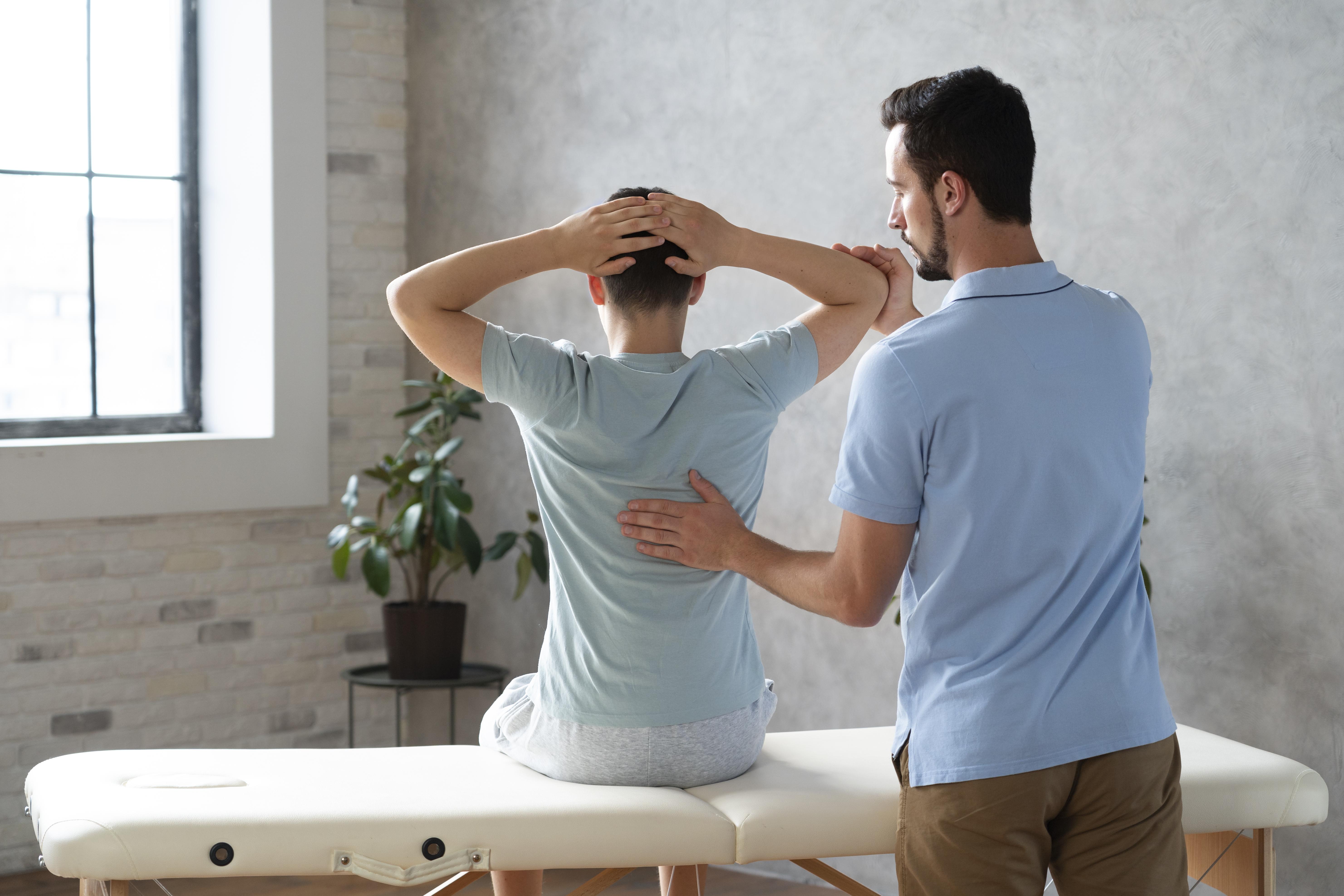 Physiotherapist helping patient with rehabilitation