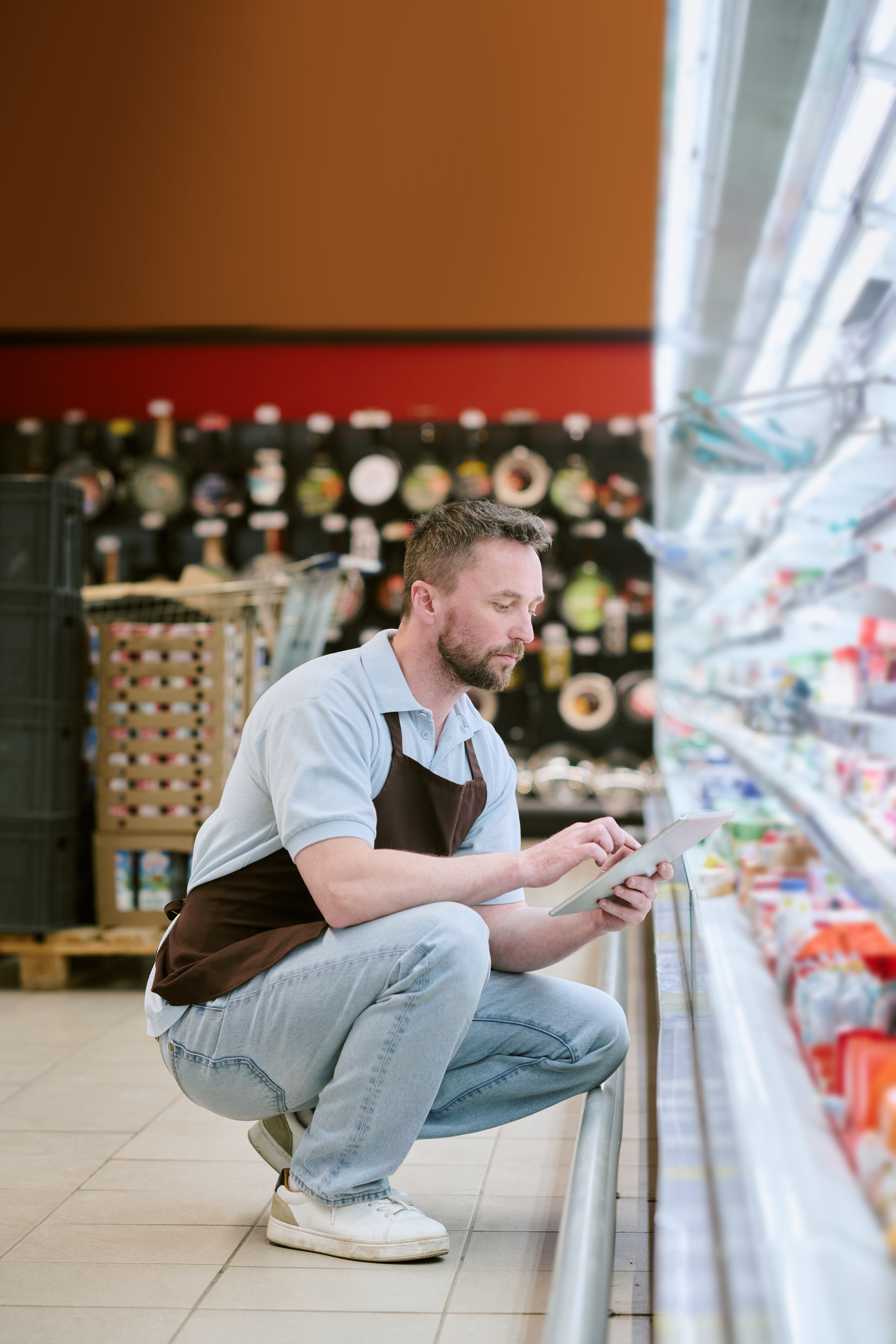 Retail worker restocking shelves